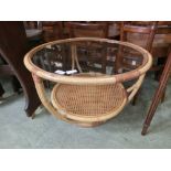 A bamboo,wicker, and glass topped occasional table