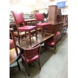 An early 20th century rectangular refectory style dining table with a set of four red rexine