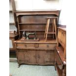 A mid-20th century oak dresser having plate rack to top, the base having two drawers above