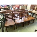A set of twelve reproduction mid-20th century design rail back dining chairs with solid seats