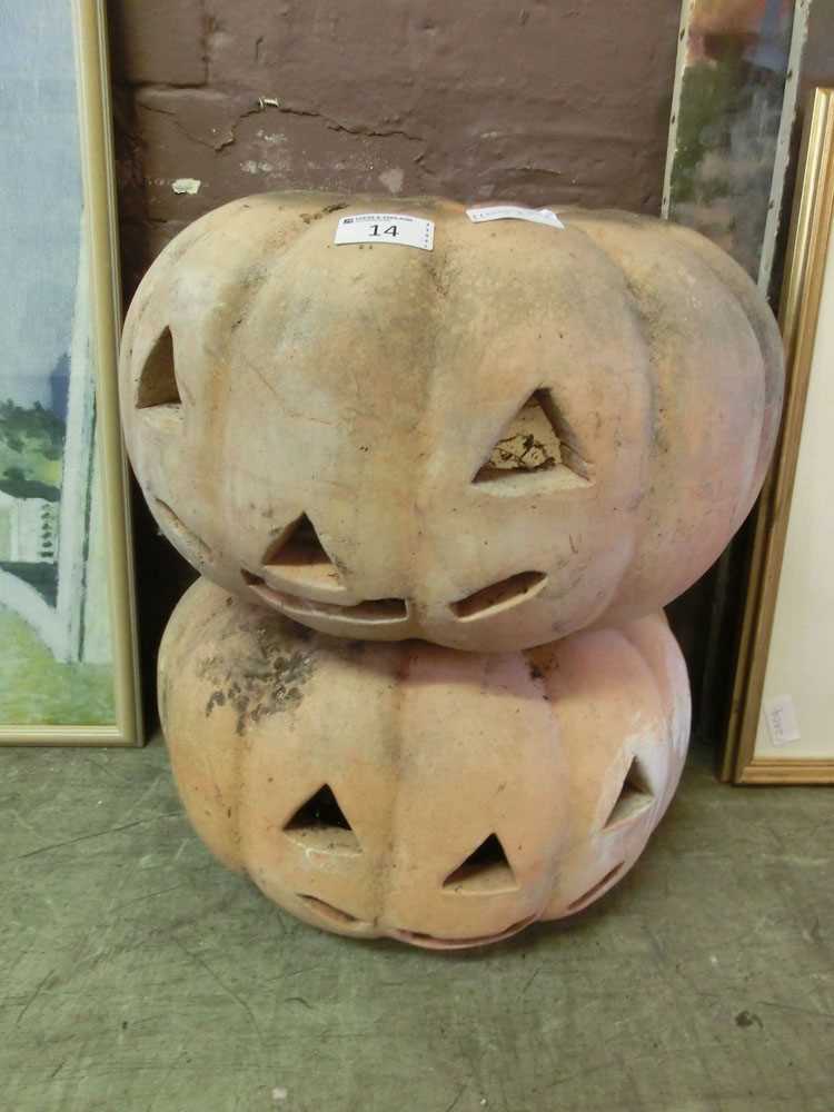 A pair of terracotta carved pumpkin outdoor light holders