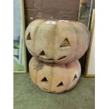 A pair of terracotta carved pumpkin outdoor light holders