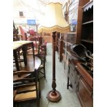 A mid-20th century walnut standard lamp with shadeLamp height measures: 153cm(To base of bulb).