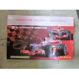 A boxed Vodaphone Maclaren Mercedes racing car set