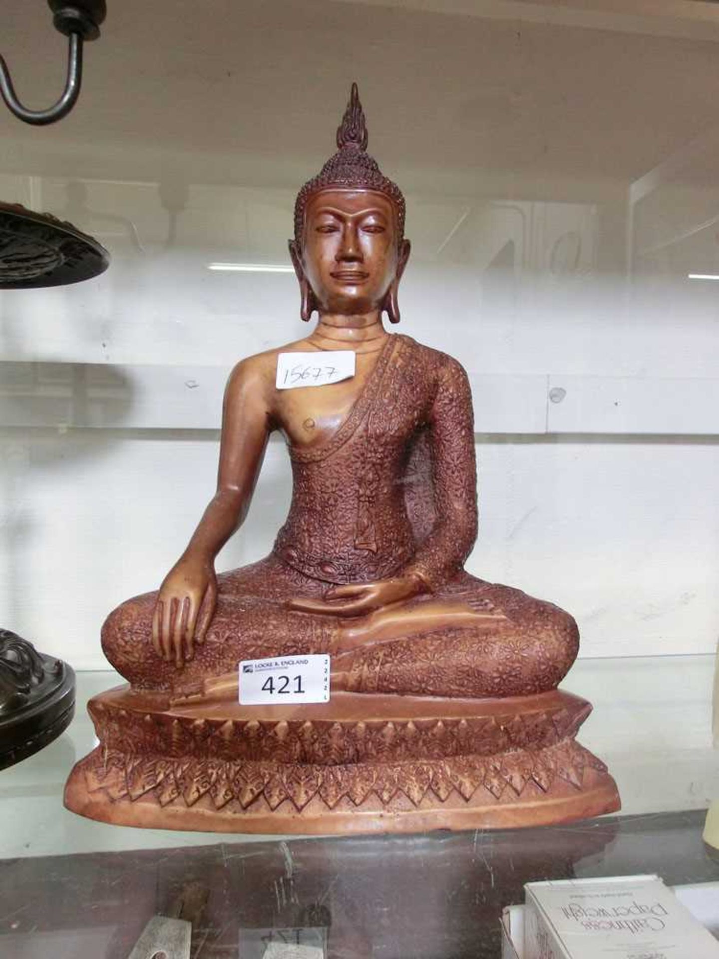 A moulded model of a sitting Buddha