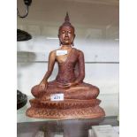 A moulded model of a sitting Buddha