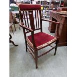 An Edwardian mahogany inlaid open armchair