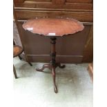 A mahogany pedestal tilt top table