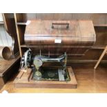 A walnut cased manual sewing machine