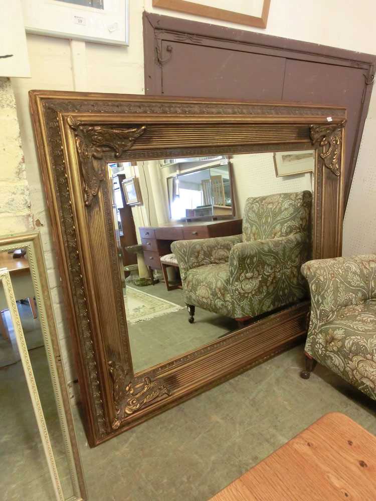 A large ornate gilt framed bevel glass mirror