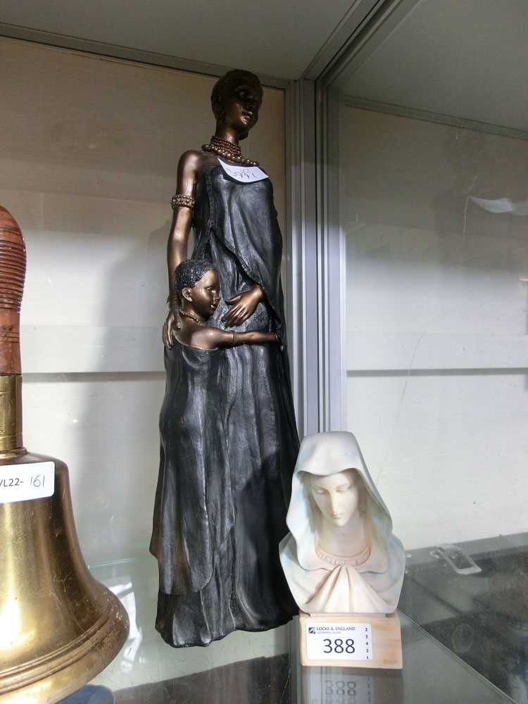 A moulded bust of a lady along with a moulded figure of African style lady with child