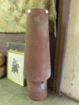 A conical terracotta chimney pot