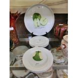 A large Limoges plate with fruit design along with six matching smaller plates
