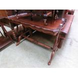 A reproduction mahogany rectangular occasional table with turned crossmember underneath