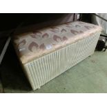 A white painted Lloyd Loom ottoman