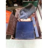 A tray containing an old oil can, measuring tape, carved panels etc.