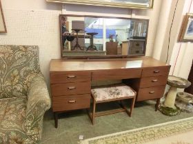 A mid-20th century teak dressing table with triple vanity mirror and stool
