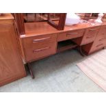 A mid-20th century teak dressing table