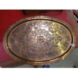 An eastern embossed oval brass tray