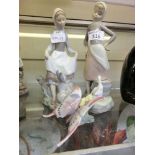 Three Lladro figurines to include a girl with a goose, a girl with a rabbit, and a butterfly on a