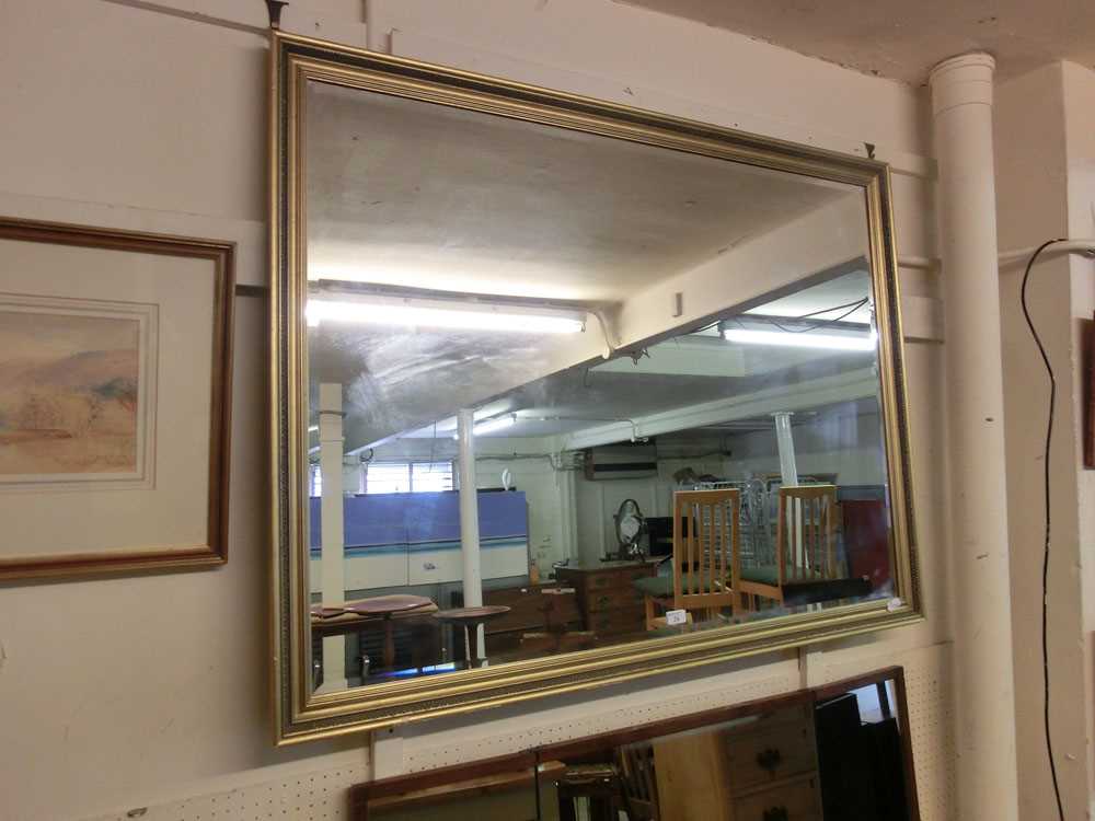 A large gilt framed bevel glass mirror