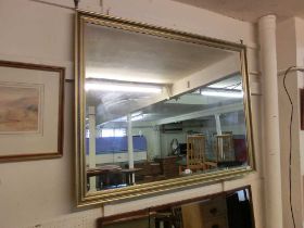 A large gilt framed bevel glass mirror