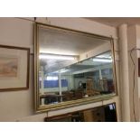 A large gilt framed bevel glass mirror