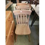 A set of three modern pine spindle back dining chairs