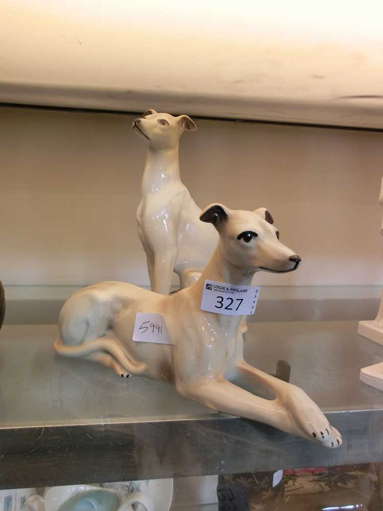 A pair of ceramic figurines of greyhounds