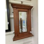 An early 20th century oak framed bevel glass rectangular mirror