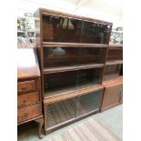 A mid-20th century four tier glazed bookcase