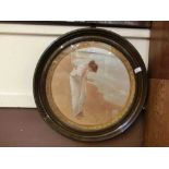 A circular framed and glazed print of young lady on beach