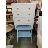 A blue painted table and cream painted chest