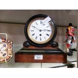 A mantle clock with Roman numerals to face