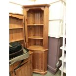 A modern pine full height corner cupboard
