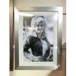 A framed and glazed poster of Dolly Parton