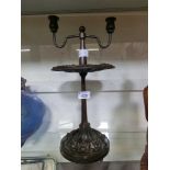 An early 20th century embossed pedestal metal candelabra