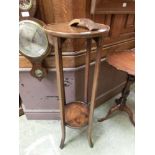 An early 20th century oak two tier jardiniere stand