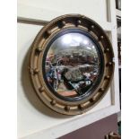 A gilt circular convex mirror