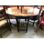 An early 20th century oak gate leg table with barley twist supports