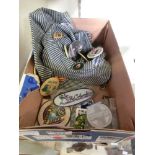 A box containing two hats with badges and a selection of sewing badges