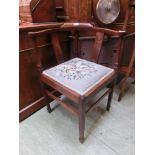 An Edwardian inlaid mahogany corner chair with a needlework seat