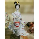 An oriental style ceramic figurine of a lady