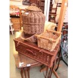 A wicker picnic basket together with two other wicker baskets