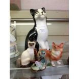 Four ceramic figurines of animals to include Royal Doulton cat, large Price Kensington cat, etc