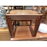 A nest of three mid-20th century teak occasional tables