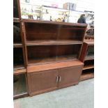 A mid-20th century teak part glazed bookcase with cupboard doors to base