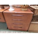 A mid-20th century teak chest of four long drawers