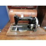 A dome cased manual sewing machine by Keynote