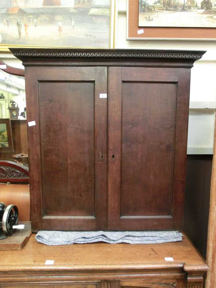 A Georgian oak two door cupboard